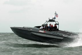 black speed boat in the ocean