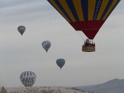 Colorful flying balloons on the beautiful rocky landscape over turkey