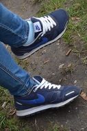 blue nike sneakers on the feet