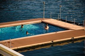 people swimming in the outdoor pool