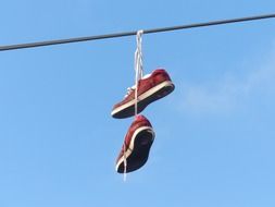 red sneakers hanging on a wire