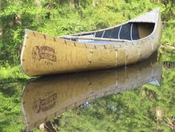 wooden canoe on the river bank