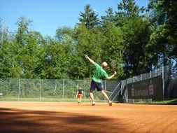 tennis competition on a field in a forest