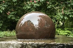 Decorative fountain in the form of a stone ball