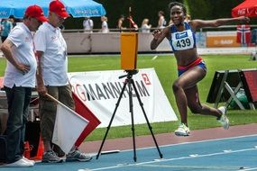 Athlete in a long jump at the finish