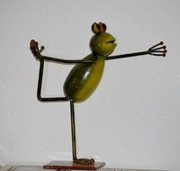 statuette of a frog with a raised leg