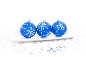 blue christmas balls on white surface