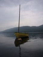 yellow wooden boat on the lake