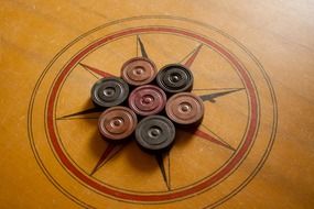 cardboard coins on a wooden board