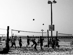 black and white photo beach volleyball game