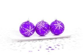 purple christmas balls on white surface