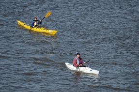 two women in kayaks on water