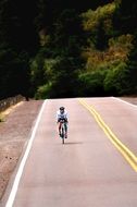 the cyclist rides on a flat road