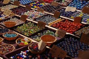 colorful glass balls on the counter in the market