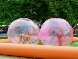 swimming humans in beach balls