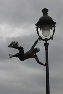 young man on a lantern in paris