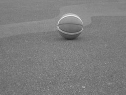 basketball ball on asphalt in black and white image