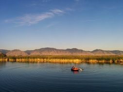 Paddle boat in the water and the mountains