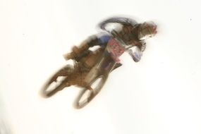 Blurred silhouette of a motorcyclist in a jump