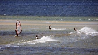 kitesurfers ride the high waves