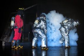 firefighters near the smoke at night