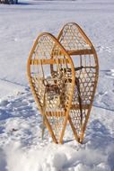 weaved snowshoes stands up in snow