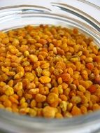 yellow pollen balls in a transparent jar