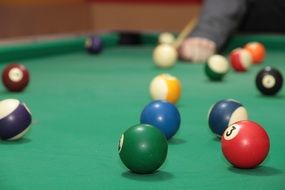 green pool table with multicolored balls