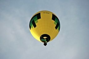 yellow hot air balloon in the blue sky