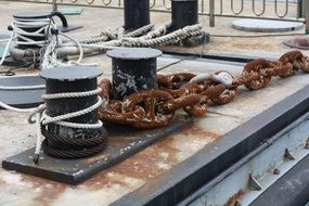 rusty chains on stakes in the port