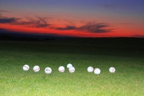 many balls on the green grass on the golf course
