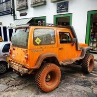 Big orange jeep near the house