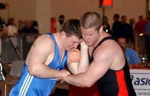 athletes are fighting in the ring