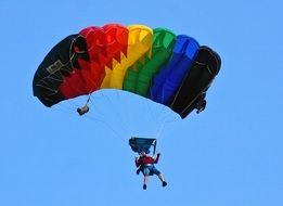 parachutist with multi-colored parachute