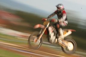 Blurred view of a motorcyclist in a jump