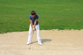 woman golfer in white pants