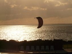 kitesurfer on the shore of the evening sea