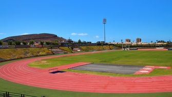 athletics track on stadium under blue sky