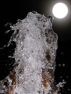 fountain at night under the moon