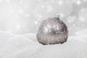 gray christmas ball on the snow