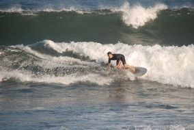 surfer on foamy sea wave