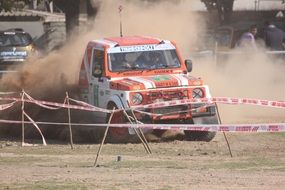 Racing car on a rally in the dust