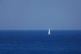 blue boat on the horizon