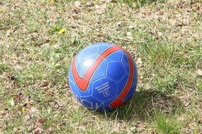 blue soccer ball with red stripe