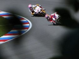 motorcycles ride on the highway close to the ground