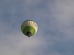 Green and white hot air balloon in sky