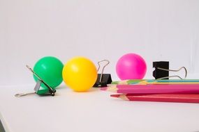 multi-colored balls near the stationery