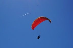 paraglider in the bright blue sky