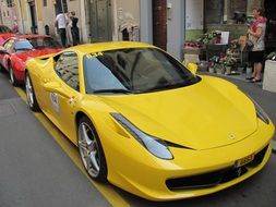 yellow supercar ferrari on a city street