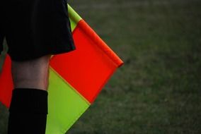 referee with a flag in football